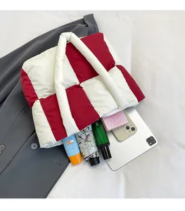 Detail view of red and white checkered nylon puffer tote showing spacious inner capacity
