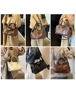 Detail view of large vintage tote bag in black, brown and white with adjustable straps