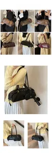 Close-up of baguette shoulder bag in black, brown and burgundy with metal buckle details