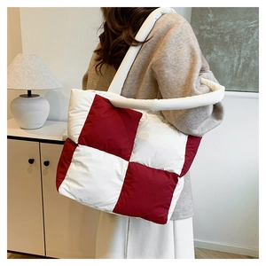 Detail view of the red and white checkered puffer tote bag with padded straps