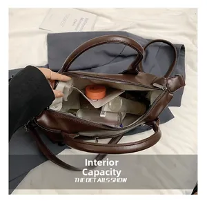 Top view of spacious internal capacity of dark brown tote bag with various personal items