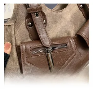 Detail of vintage tote bag showing canvas stitching and dark gunmetal zipper hardware