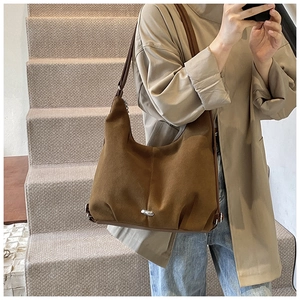 Brown corduroy tote bag detail showing fine texture and casual shoulder strap style