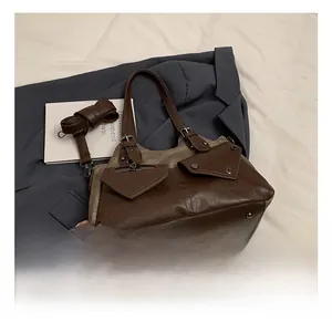 Detail view of brown vintage textured leather tote bag with functional pockets and zippers