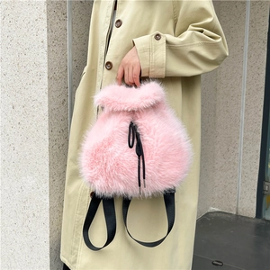 Chic pink faux fur drawstring backpack with black straps for stylish travel
