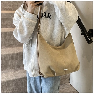 Minimalist khaki suede hobo tote bag with slim leather straps and oval metal detail