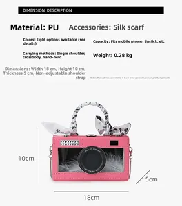 Detailed view of pink camera-shaped bag with silk scarf handle and feather decor
