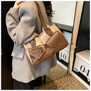 Close-up of vintage tote bag showing brown leather and grey canvas texture detail