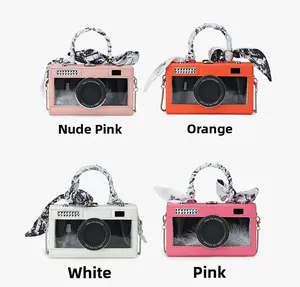 Detail of creative camera-shaped crossbody bags in four colors with silk scarf handles