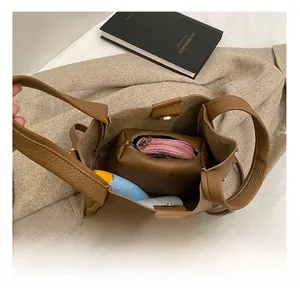 Spacious interior of brown pebbled leather bucket bag with matching zipper pouch