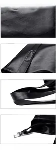 Detail of black pebbled leather texture, stitching, and silver metal zipper on tote bag