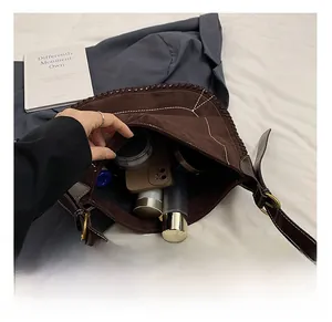 Close-up of brown suede bucket bag interior showing spacious capacity for daily items