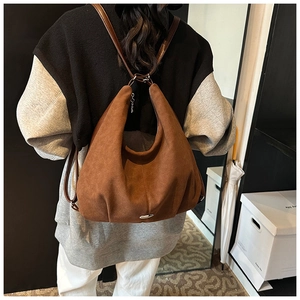 Brown frosted leather tote bag shown on model back, large capacity for daily commute
