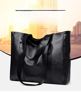 Close-up of black lychee grain PU leather tote bag showing detailed stitching and texture