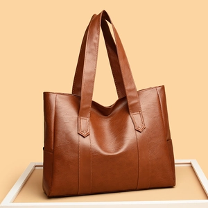 Minimalist large PU leather tote bag in caramel brown with functional side pockets