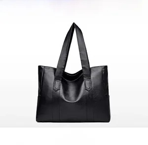 Front view of black PU leather tote bag showing soft lychee texture and wide handles