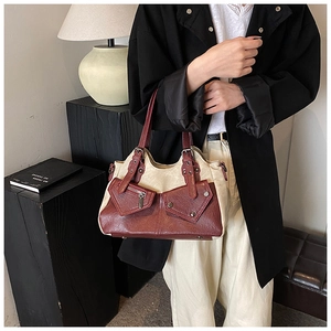Detail of vintage tote bag showing beige leather拼接 and burgundy pockets with metal zipper