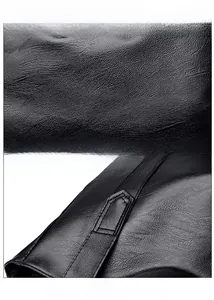 Close-up of premium black PU leather with litchi grain texture and precise stitching detail