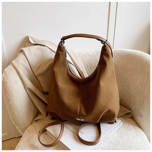 Detail of dark brown faux suede tote bag with large capacity and matte vintage texture
