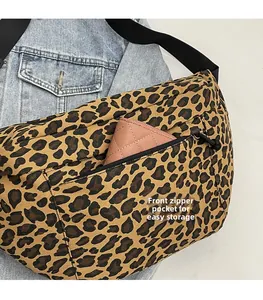 Front zipper pocket of leopard print crossbody bag showing storage for a wallet