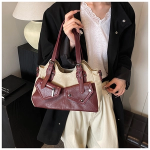 Close-up of vintage burgundy faux leather and off-white canvas crossbody bag for women