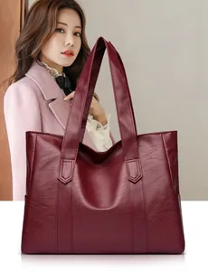 Detailed close-up of dark red PU leather tote bag showing rich lychee grain texture