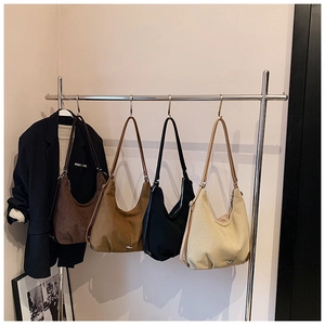 Detailed close-up of premium suede Hobo bags in earthy tones with leather straps
