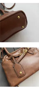 Detail of vintage brown tote bag showing protective bottom rivets and side tag