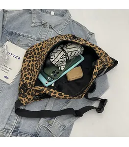 Spacious leopard print crossbody bag showing interior storage for phone and umbrella