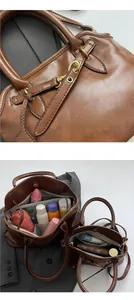Detailed close-up of gold metal hardware and spacious interior of the vintage tote bag