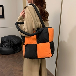 Quilted checkerboard puffer tote bag with black and orange color block design for women