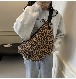 Detailed close-up of large capacity leopard print chest bag with adjustable black strap