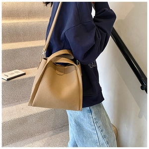 Detailed side view of khaki lychee grain leather tote bag with CHIC & BAGS logo text