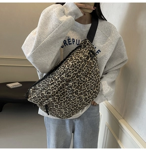 Detailed view of the leopard print crossbody bag with adjustable wide black nylon strap