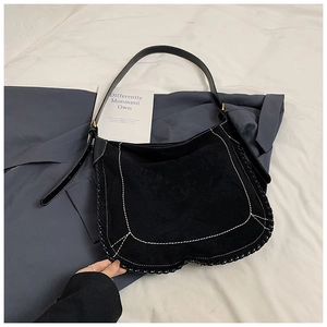 Detail of black frosted tote bag with white contrast stitching and woven edge