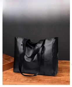 Close-up of Nappa texture on large black PU leather tote bag with long shoulder straps