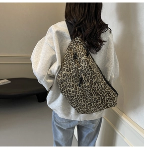 Macro detail of the leopard print fabric texture and wide black adjustable strap