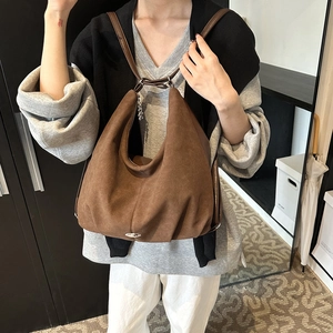 Brown faux suede tote bag with minimalist stitching and silver logo for commuting