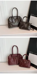 Detail view of large and small retro leather tote bags with elegant gold hardware