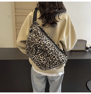 Close-up of leopard print fanny pack worn as a crossbody bag in a casual setting
