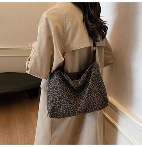 Side view of large leopard print tote bag styled with modern casual autumn outfit