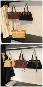 Detail view of vintage matte leather tote bags with belt buckles in three colors