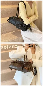 Detail of elegant baguette shoulder bag with slim straps and magnetic pocket design