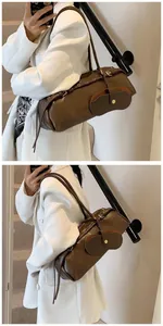 Detail of vintage brown baguette bag featuring a functional matching glasses case charm