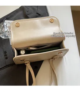 Interior view of off-white leather crossbody bag with spacious storage and zippered pocket
