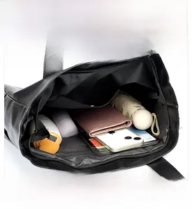 Interior view of large capacity black PU tote bag with pockets for daily essentials
