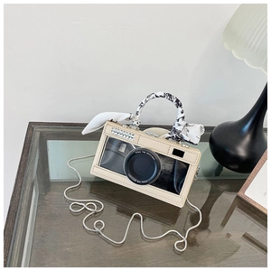Detail of camera-shaped bag with floral silk scarf handle and rhinestone accents