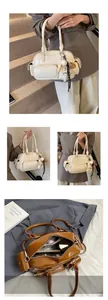 Detail view of stylish multi-pocket PU leather bowling bags in white and brown