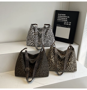 Detailed view of three leopard print tote bags in black, dark brown, and khaki with straps