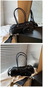 Detail of black faux leather baguette bag with gold buckle and attached coin purse
